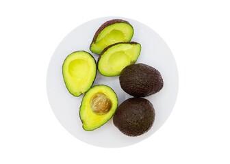 Avocadoes on the plate whole and halves 
