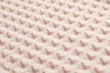 Clean beige waffle towel as background, closeup