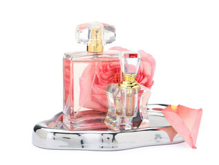 Different perfume bottles and rose isolated on white