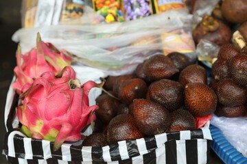 Different fresh exotic fruits at market, closeup