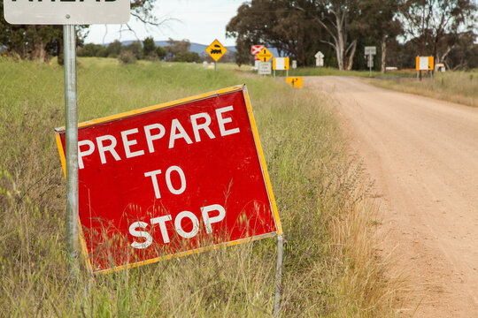 Prepare to stop sign before roadworks and train line