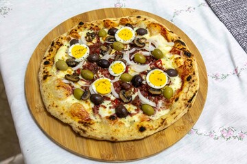 Original Brazilian pizza with olives, mushrooms, grated pepperoni, onion, red pepper, oregano and...