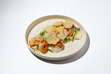 A delightful shrimp salad, vibrant with fresh greens and colorful toppings, rests on a clean, minimalist plate. Perfect for enjoying during a sunny afternoon lunch with friends