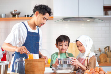 Asian muslim family are preparing and cooking in the kitchen.