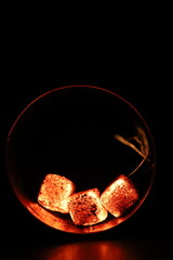 Glowing coals with glitch style lighting, enriched by noise, effect and grain details, create a mystical atmosphere in the dark. A vivid sense of heat and depth surrounds the image