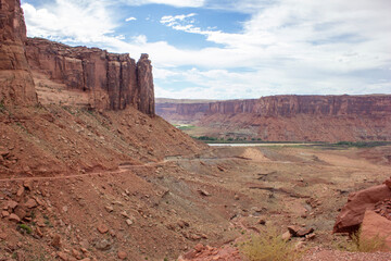 Breathtaking view of the red rock formations and canyon landscape under a partly cloudy sky in the American Southwest