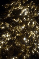 Sparkling golden lights against a dark background.