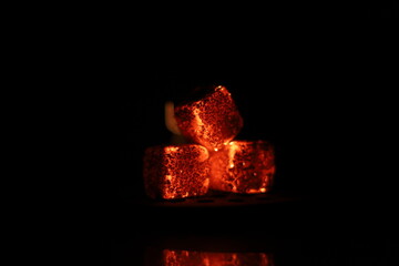Glowing coals with glitch style lighting, enriched by noise, effect and grain details, create a...