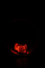 Glowing coals with glitch style lighting, enriched by noise, effect and grain details, create a mystical atmosphere in the dark. A vivid sense of heat and depth surrounds the image