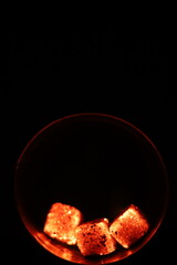 Glowing coals with glitch style lighting, enriched by noise, effect and grain details, create a mystical atmosphere in the dark. A vivid sense of heat and depth surrounds the image