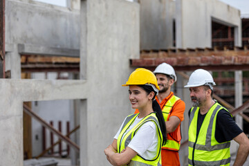 Civil engineers from different cultures stand to support a women supervisor for her leadership in a factory. Women leadership in a construction factory