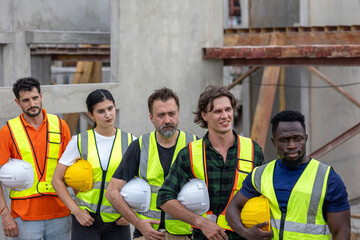 A group of civil engineers from different ethnicities and experiences stands with arms crossed...