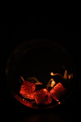 Glowing coals with glitch style lighting, enriched by noise, effect and grain details, create a mystical atmosphere in the dark. A vivid sense of heat and depth surrounds the image