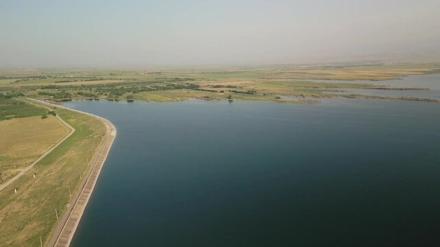 Aerial view of reservoir dam and rural landscape near Djizak in Uzbekistan
