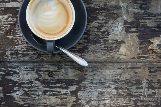 flat white coffee on a dark wooden background