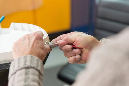 Close up of Mans Hands Working on Model Boat