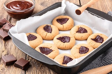 Chocolate-filled cookies in a baking pan.