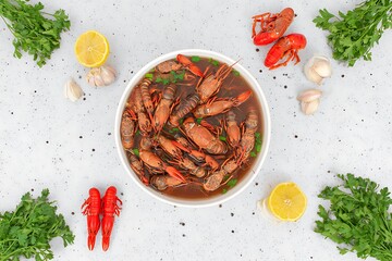 Crayfish stew in a white bowl, garnished with herbs.