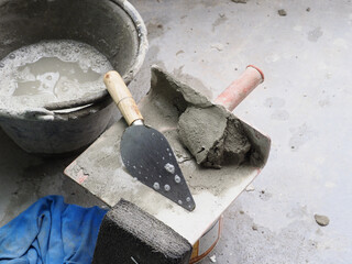 Cement and tool on floor seems worn but gray color palette creates sense of grit and determination...