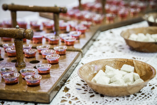 Communion cups of juice in trays and bread for a church service