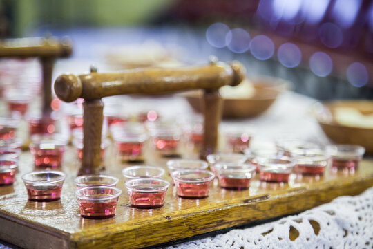 Communion cups of juice in trays and bread for a church service