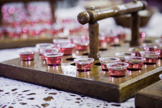 Communion cups of juice in trays and bread for a church service