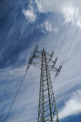 A tall power tower with many wires coming out of it