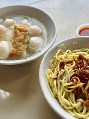 Traditional fishball noodle soup and dry tossed egg noodles with crispy shallots – Asian street food