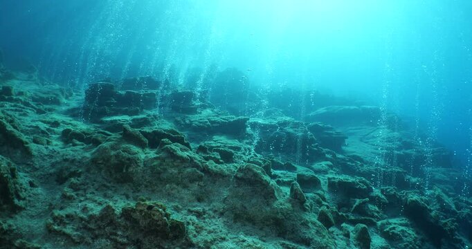 bubbles coming out of a cave underwater scuba divers to explore and enjoy