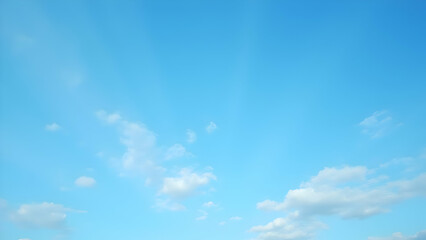 A bright blue sky with scattered white fluffy clouds