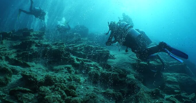 bubbles coming out of a cave underwater scuba divers to explore and enjoy