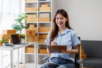 Young attractive asian woman sme owner startup business work happy with box at home prepare parcel...