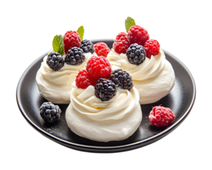 Mini pavlova meringue desserts topped with whipped cream fresh raspberries blueberries blackberries and mint on black plate isolated on transparent background
