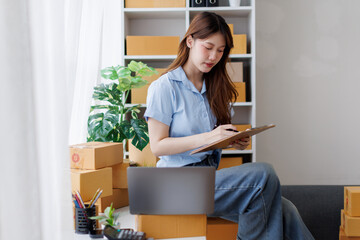 asian woman receive order on laptop. Startup small business entrepreneur SME, Success young Asian...