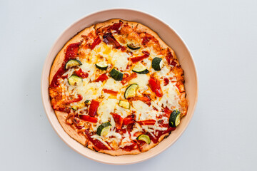 vegetarian pizza with zucchini capsicum and red lentil base on rustic homemade crust