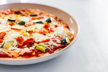 vegetarian pizza with zucchini capsicum and red lentil base on rustic homemade crust