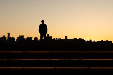 Person standing watching the sunset at Domino Park in Brooklyn