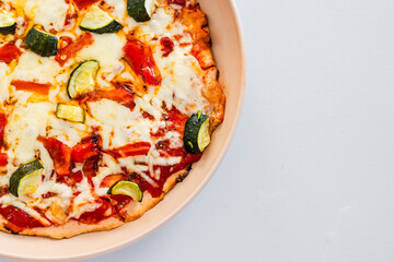 vegetarian pizza with zucchini capsicum and red lentil base on rustic homemade crust