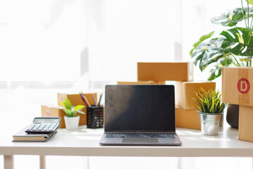 Equipments for SME online business , delivery business laptop, barcode, boxes, Small and Medium Enterprises (SMEs) stocks or parcels. Small business working at home office.
