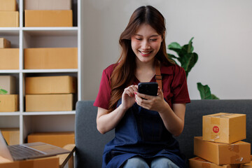 Young asia Small and Medium Enterprises (SMEs) seller woman happy work on laptop busy cellphone...