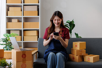 Young asia Small and Medium Enterprises (SMEs) seller woman happy work on laptop busy cellphone...