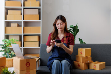 Young asia Small and Medium Enterprises (SMEs) seller woman happy work on laptop busy cellphone...