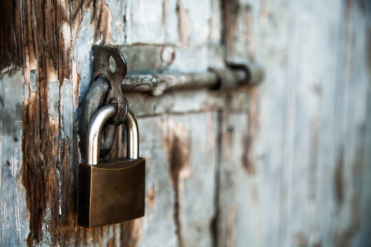 Detail of padlocked bolt on a blue door