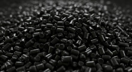 Obraz premium Close-up of a pile of dark black plastic pellets