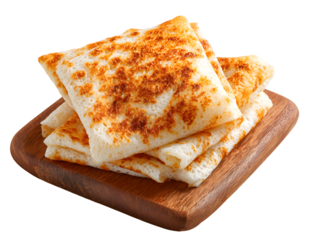 Stack of folded crispy crepes on wooden board isolated on transparent background