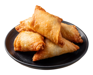 Crispy deep-fried samosas stacked on black plate isolated on transparent background
