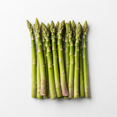 Asparagus spears arranged neatly on a white background, slightly textured surface