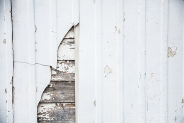 Close up of rustic timber slat panels hidden behind white wall