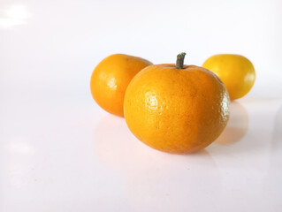 oranges and tangerinesBright oranges are beautifully arranged on a clean white background, highlighting their fresh appeal, perfect for healthy eating, and minimalist concepts.