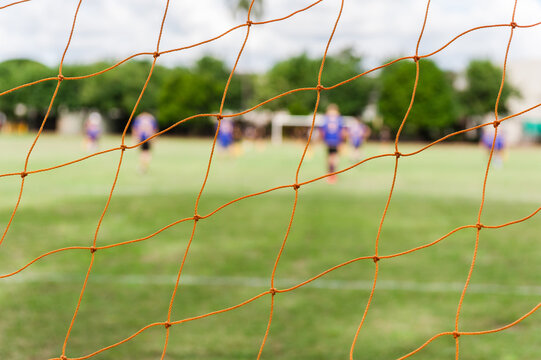 Soccer net with blurry players